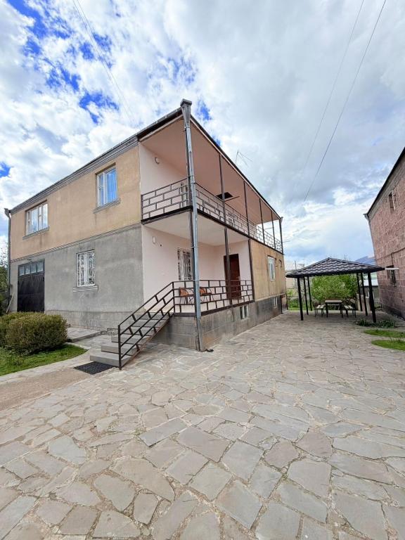 a large building with a porch and a patio at MARY in Stepʼanavan