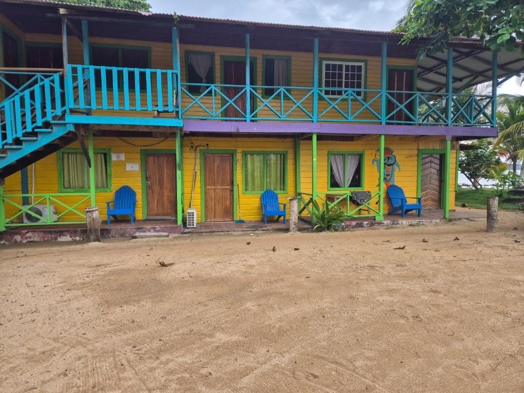 a colorful house with a balcony on top of it at Cabañas T Estefany in Bocas Town