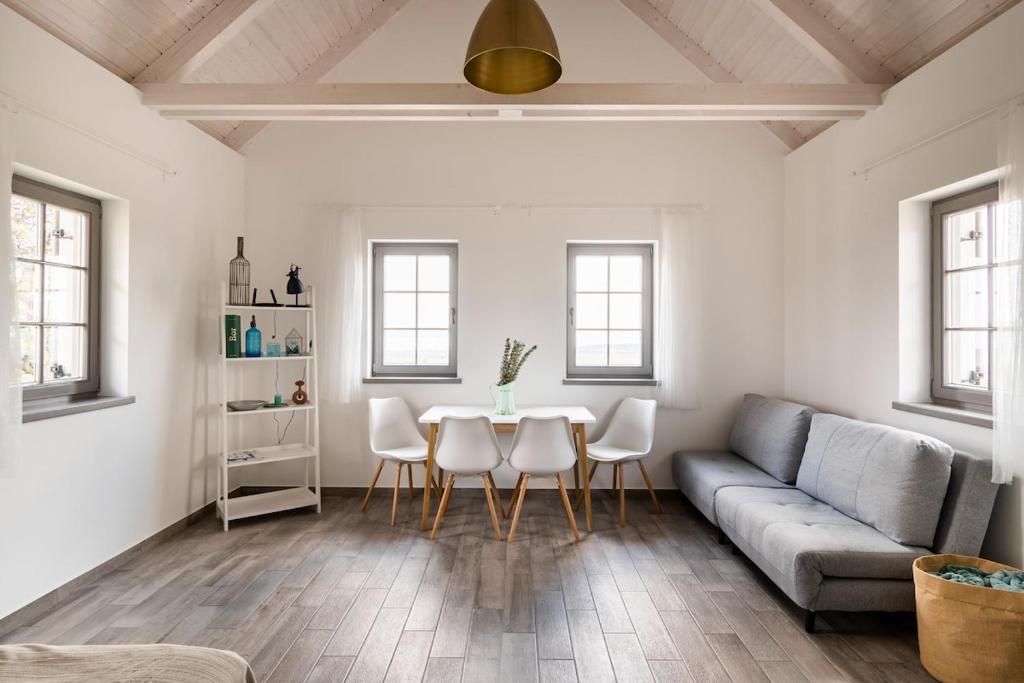 a living room with a couch and a table at 1HA Tagyon Vendégház in Tagyon