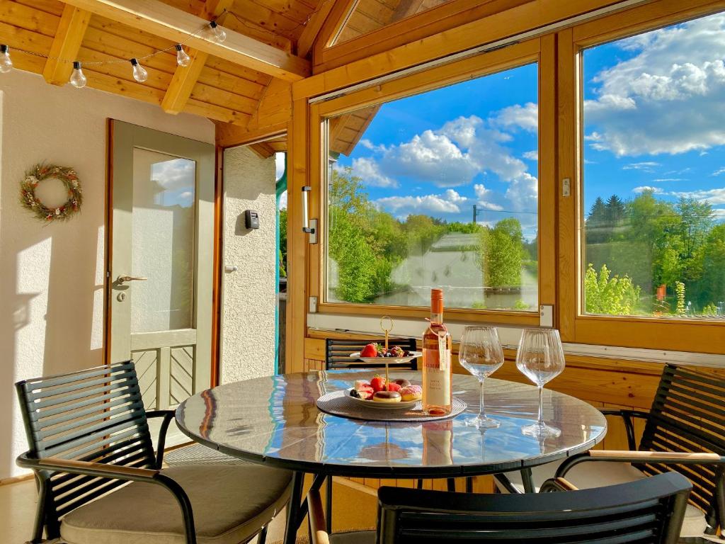 a table and chairs on a porch with wine glasses at Ferienwohnung Lea La Milan in Stockach