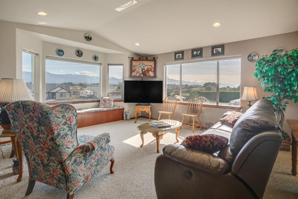 a living room with a couch and a tv at Charming Sequim House w/ Olympic Peninsula Views! in Sequim