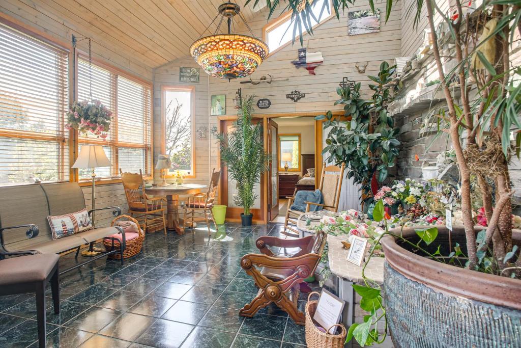 a room filled with lots of plants and a chandelier at Unique Home w/ Beautiful Mtn Views! in Sequim