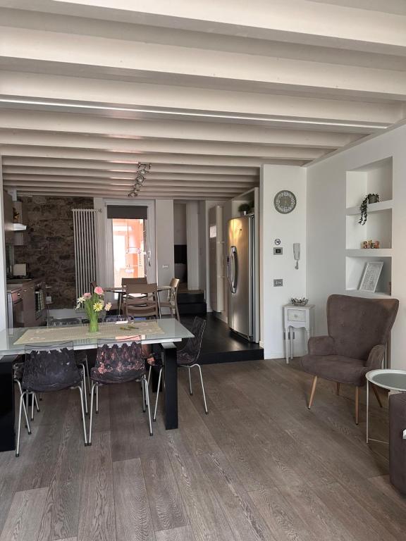 a dining room and living room with a table and chairs at Borgo&Lago Home in Castro