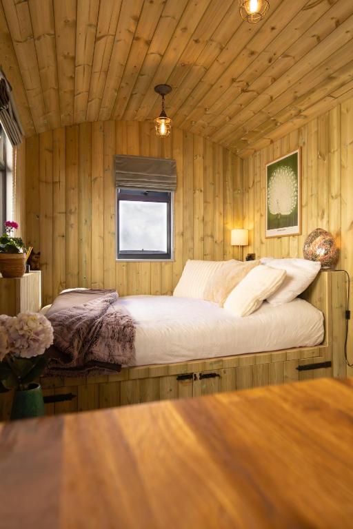a bedroom with a bed in a wooden room at Valentine in Longdown