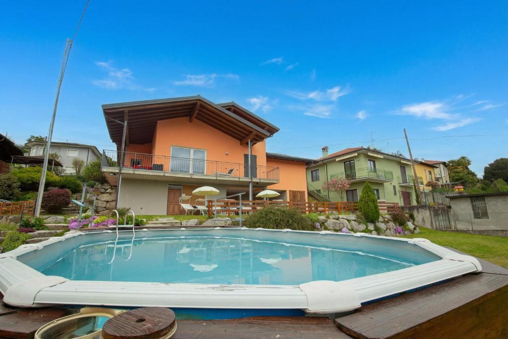 a swimming pool in front of a house at Villa Laura Private Pool and Garden near Lake Maggiore for 9 - Happy Rentals in Besozzo