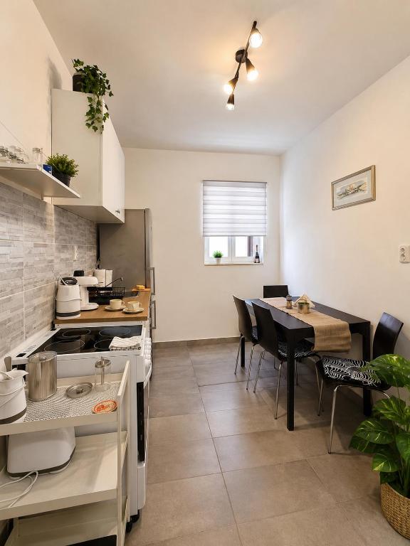 a kitchen and dining room with a table and chairs at Komiža Sea Breeze in Komiža