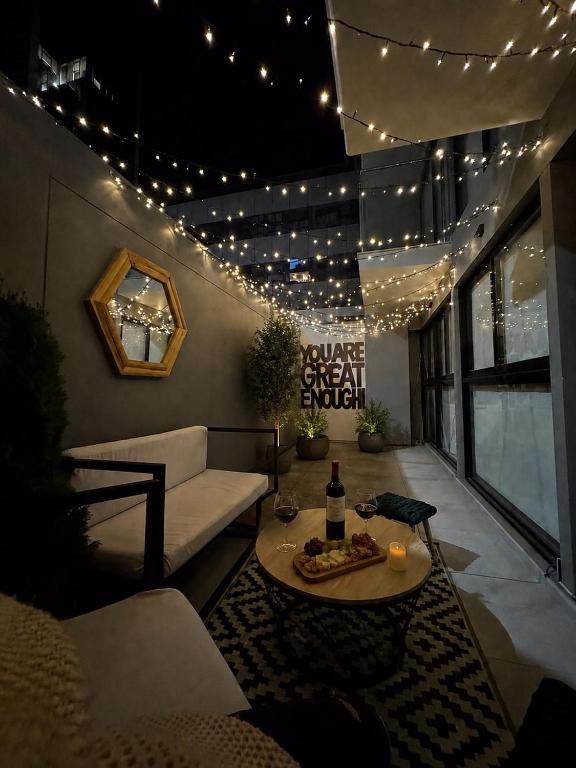 a patio with a couch and a table and lights at Luxury Towers Arequipa in Arequipa