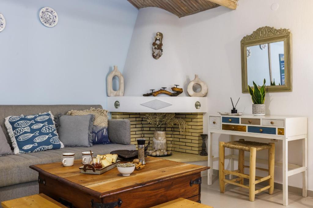 a living room with a couch and a table at Yianna Cottage Studios in Skopelos Town