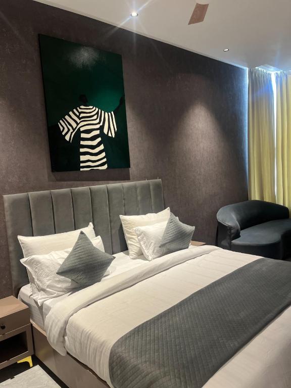 a bedroom with a bed with a painting on the wall at Hotel route 54 in Bathinda