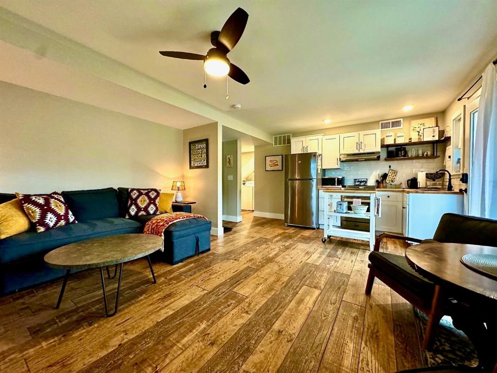 a living room with a blue couch and a kitchen at Charming 1 bedbath Suite in waterfront Cottage in Somers