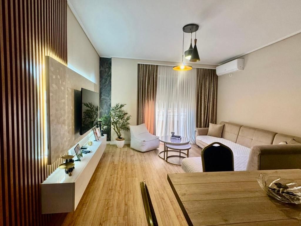 a living room with a couch and a table at Your Home Fier 2 in Fier