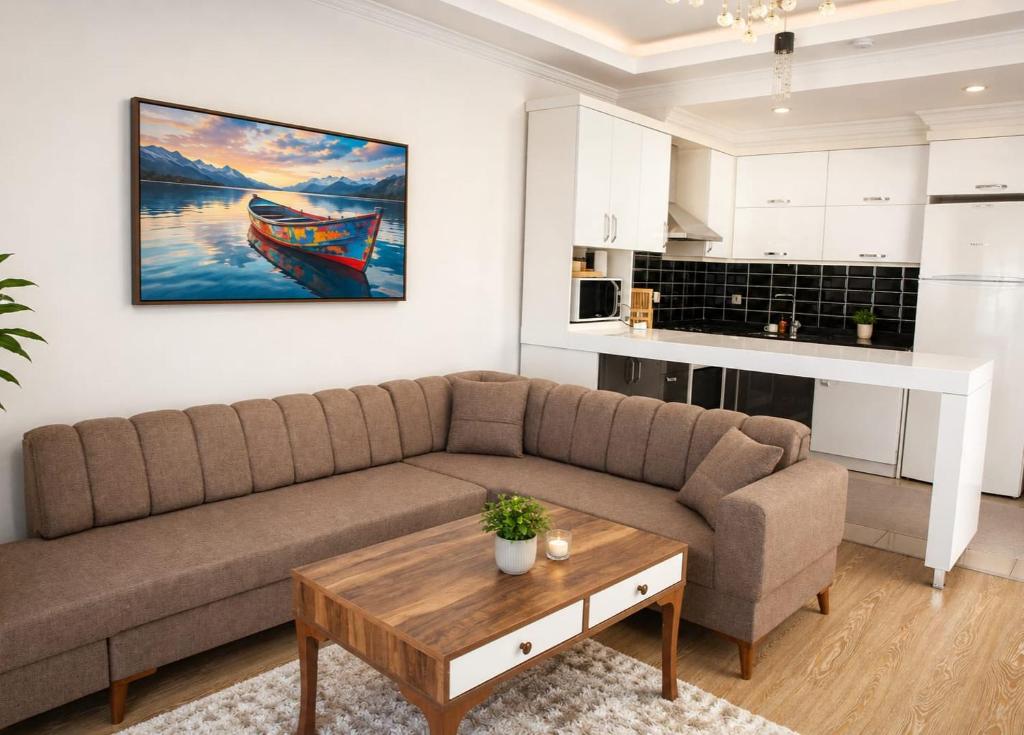 a living room with a couch and a table at Kemer Suit Residence in Kemer