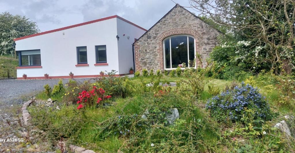 a cottage with a garden in front of it at The Haggard Self Catering Accommodation in Castleblayney