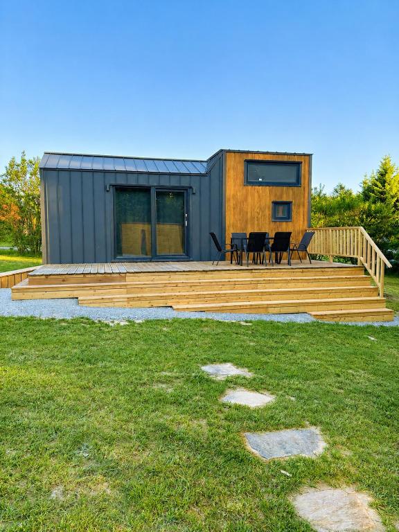 a home with a deck and a house at Tinyhouse Na Zemi in Žďár nad Sázavou