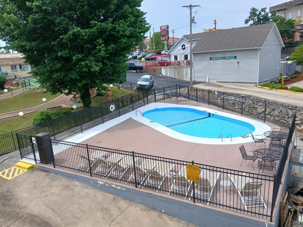 a swimming pool with a fence around it at The Boardwalk Inn in Branson