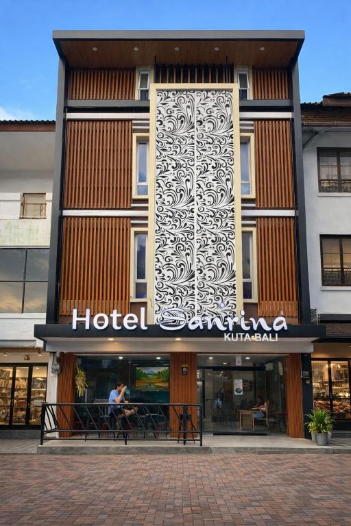 a hotel sign on the front of a building at Hotel Sanrina Kuta Bali in Kuta