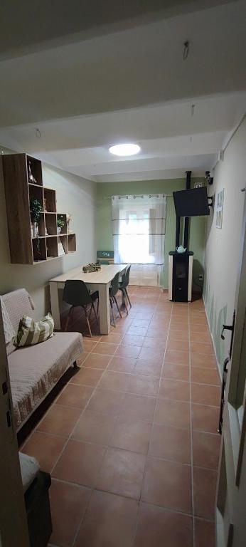 a living room with a table and chairs and a room at Mazzmarill in Pizzoferrato