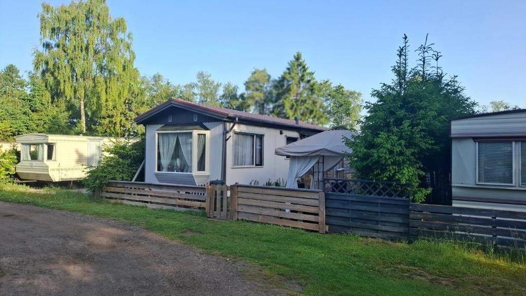a home with a fence and a house at Chalet Lieke Nr386 in Eext