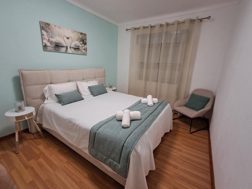 a bedroom with a bed with two towels on it at Os Robalos in Moura