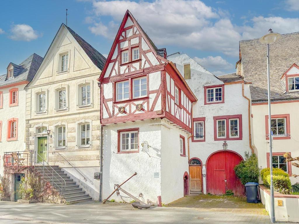 a building with a red door next to other buildings at Zum Anker in Bernkastel-Kues