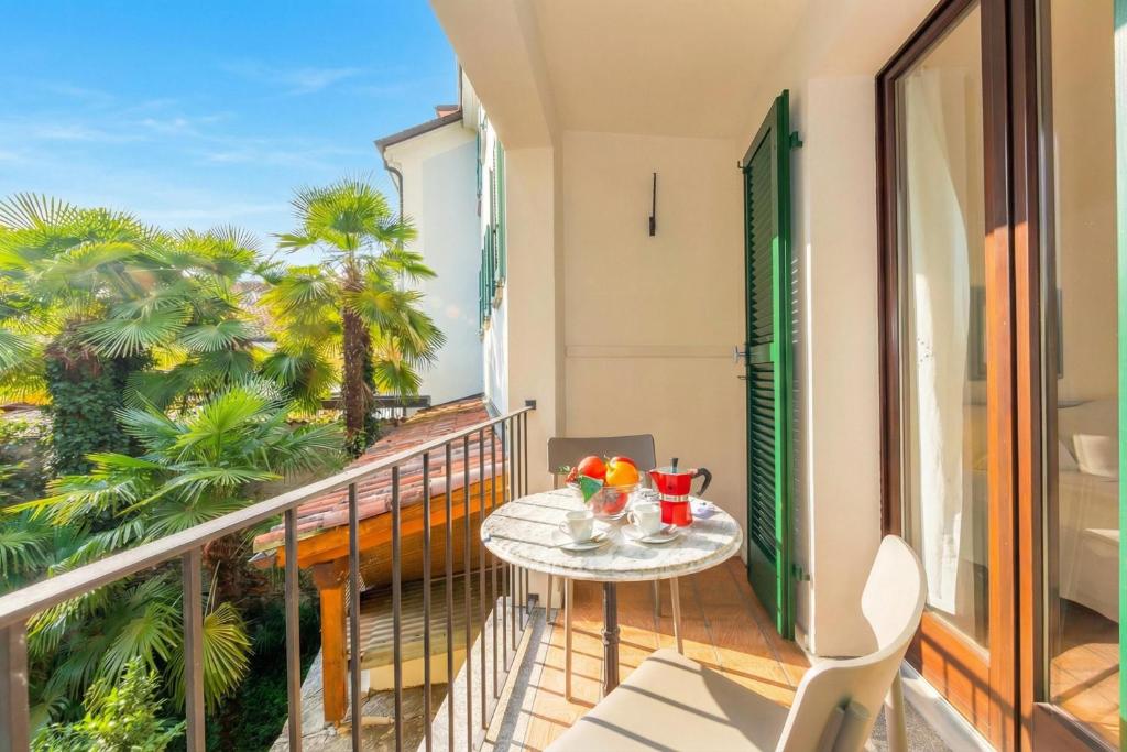 a balcony with a table and drinks on it at Casa Chiara Muralto with Balcony & Wi‑Fi - Happy Rentals in Locarno