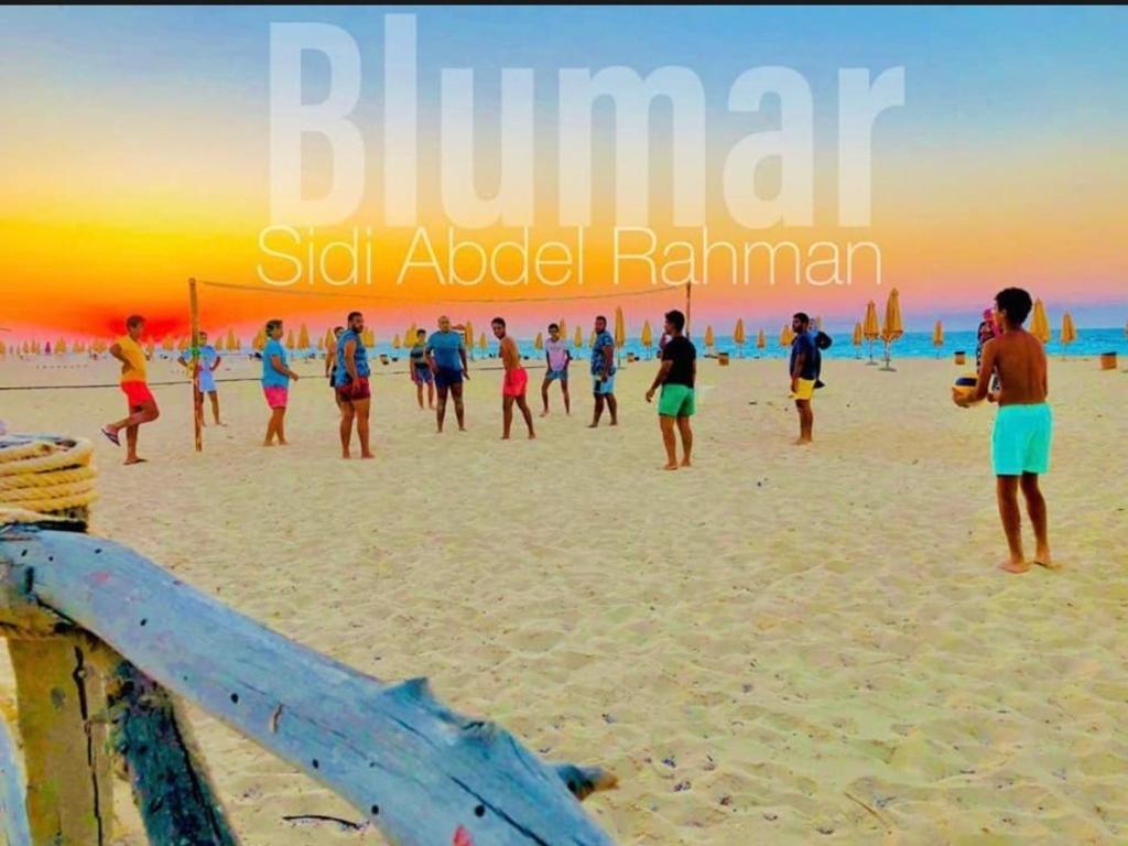 a group of people playing soccer on the beach at بلومار Blumar in El Alamein