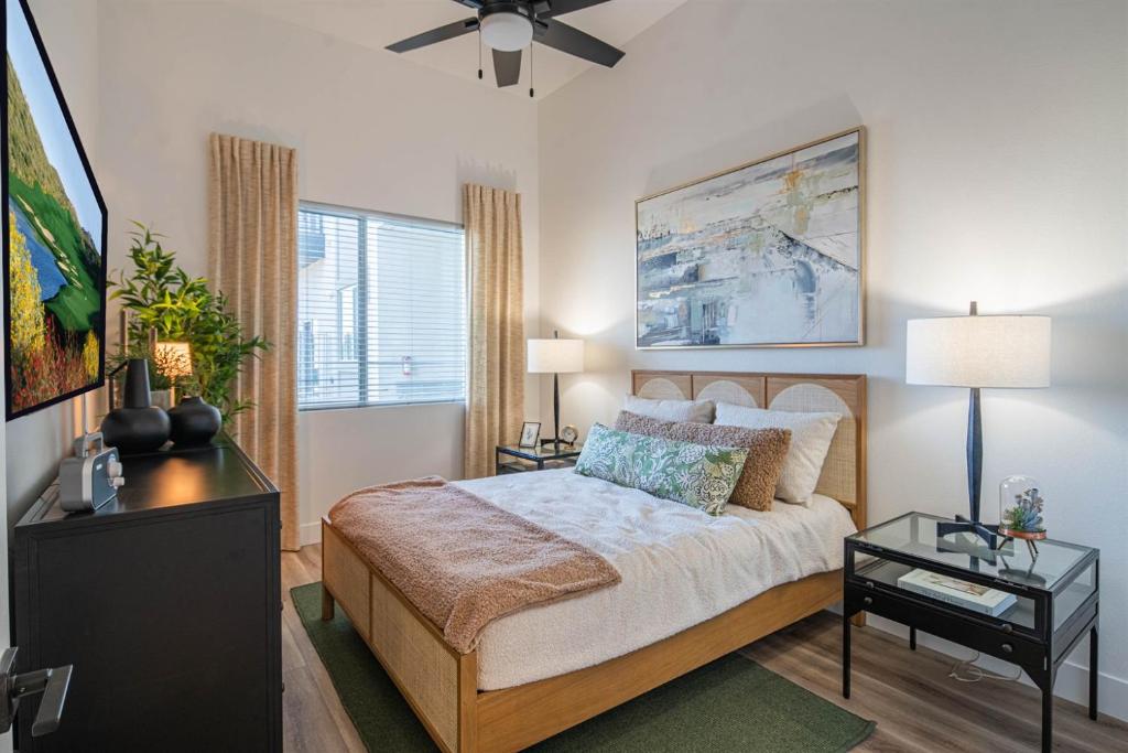a bedroom with a bed with a table and a window at Rooftop Deck, Heated Pool Nearby Golf & Sun Stay in Scottsdale