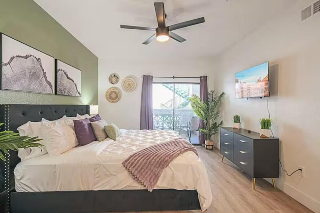 a bedroom with a bed and a ceiling fan at Remodeled King Bed Suite Sonoran Sunset Lounge in Scottsdale