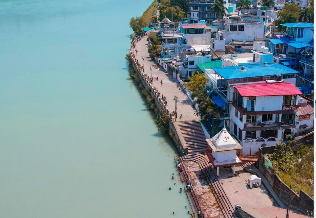 an aerial view of a city with a river at hotel tripta ganga in Rishīkesh