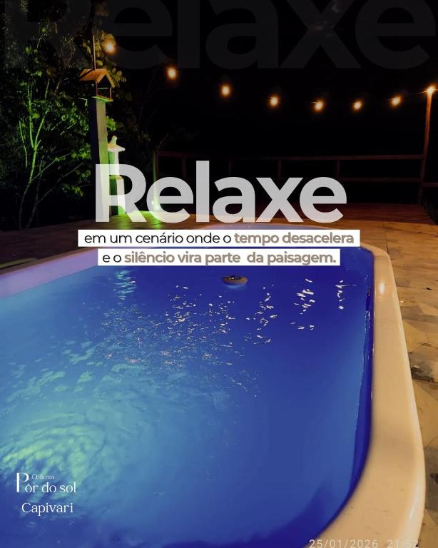 a sign for a swimming pool with a blue water at Chacara Pôr do Sol Capivari in Campina Grande do Sul