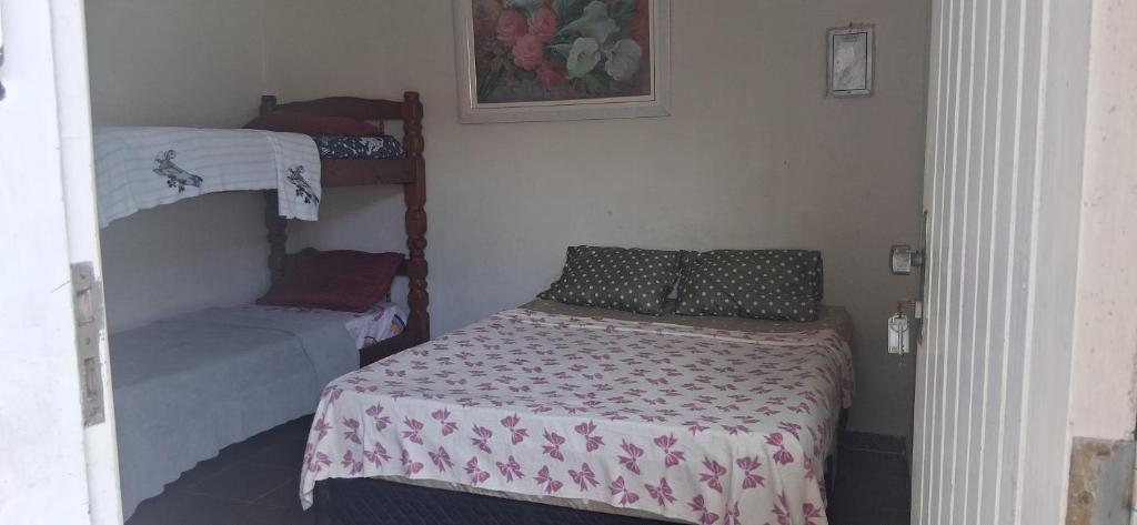 a small bedroom with a bed and a bunk bed at Loft Praia do Sonho in Itanhaém