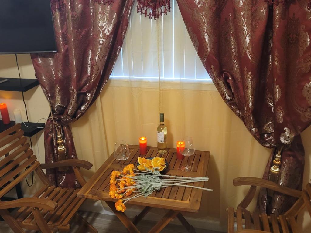 a table with two chairs and candles on it at Twin Pines Studios in Jacksonville