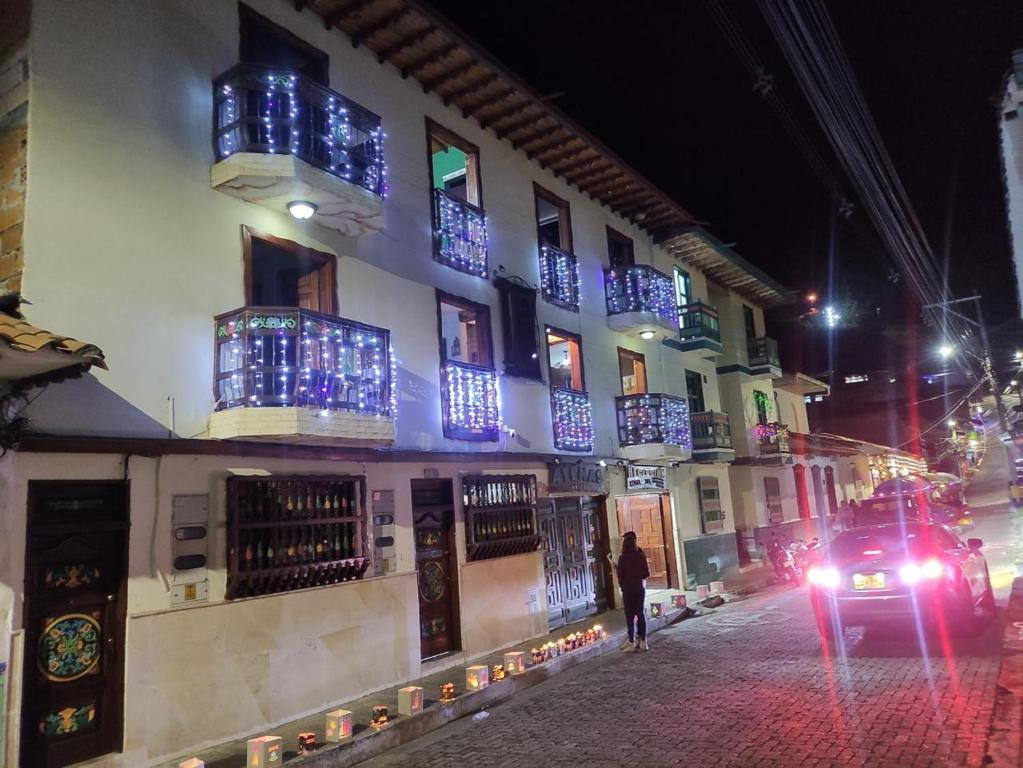 a building with blue lights on the windows at night at Hotel Atenas in Jericó