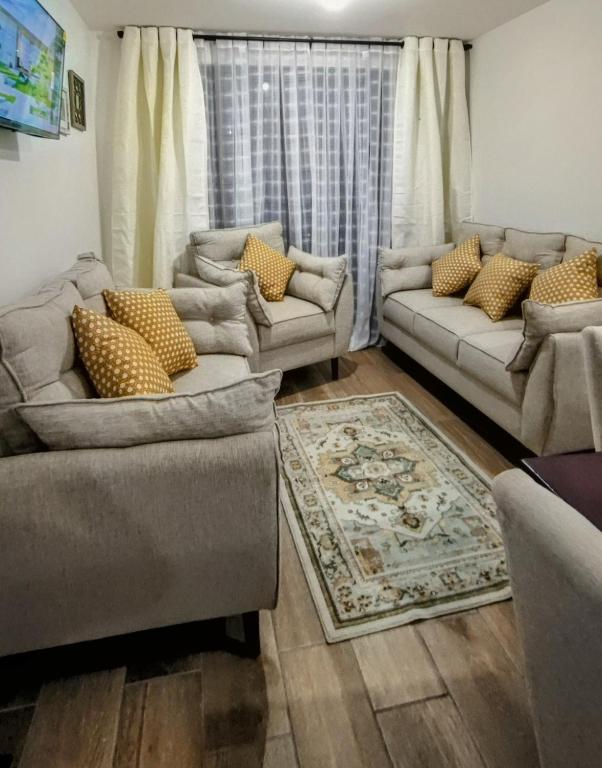 a living room with two couches and a rug at Apartamento 2 dormitorios 1 baño parqueo in Boca Monte
