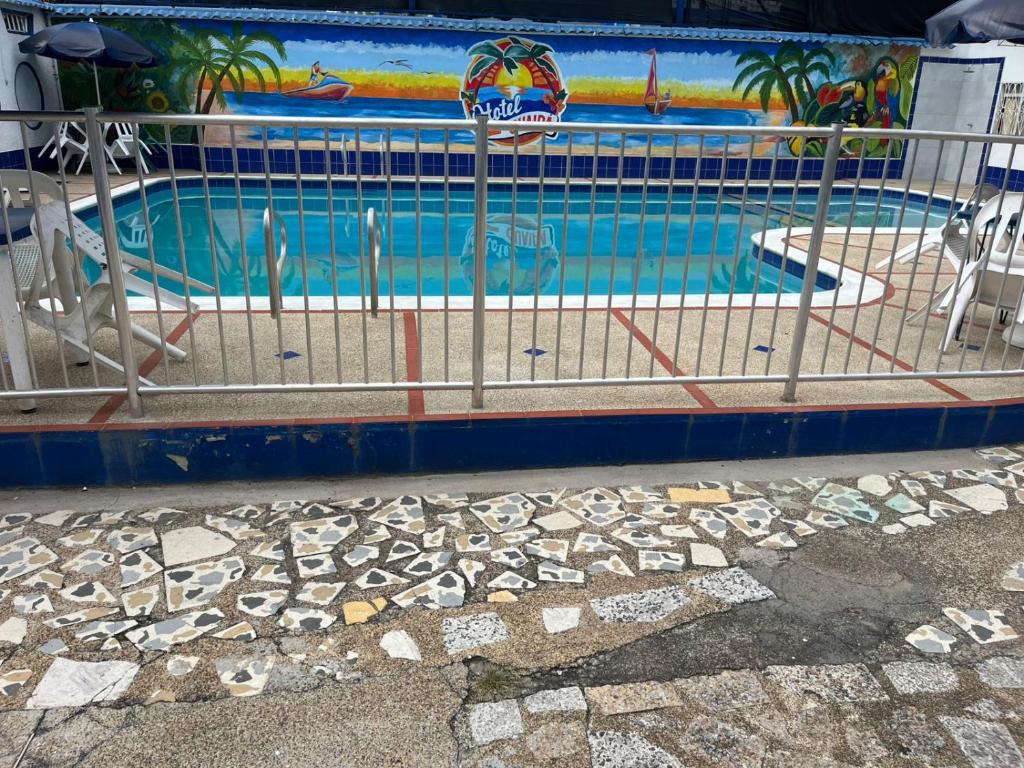 a swimming pool with a fence around it at Guiapa en melgar in Melgar