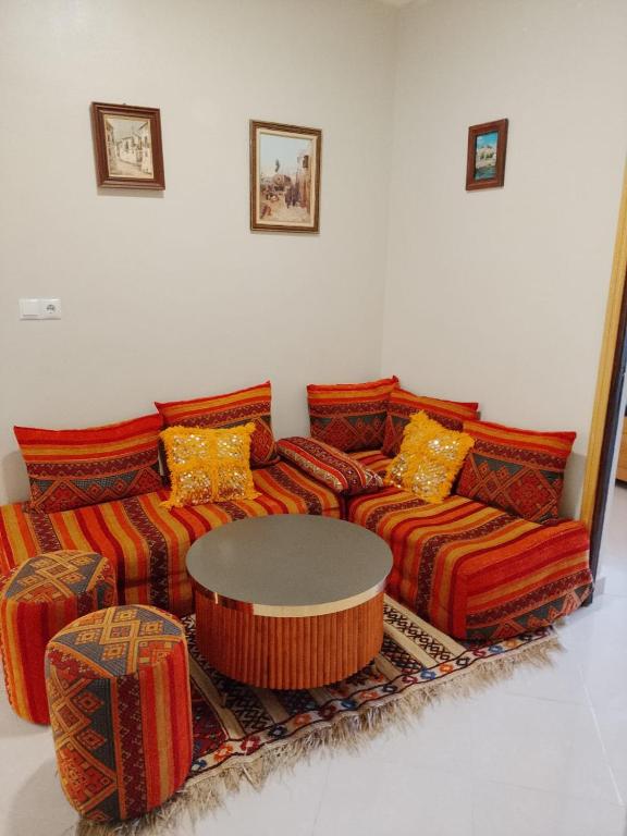 a living room with a couch and a table at Maison d'hôte Najah 1 in Khenifra