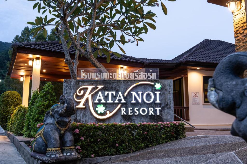 a sign for kata not resort in front of a building at Katanoi Resort in Kata Beach