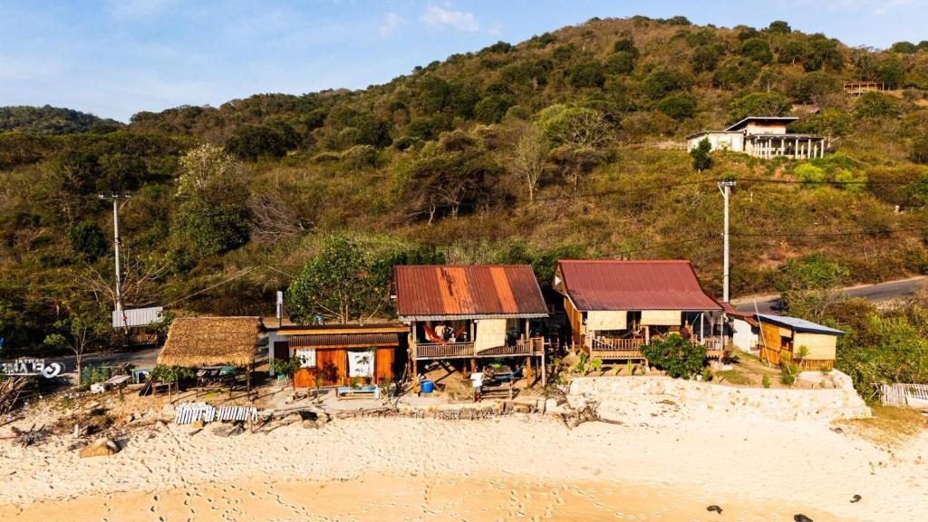 a house on a hill next to the beach at Boneputeh Homestay in Taliwang