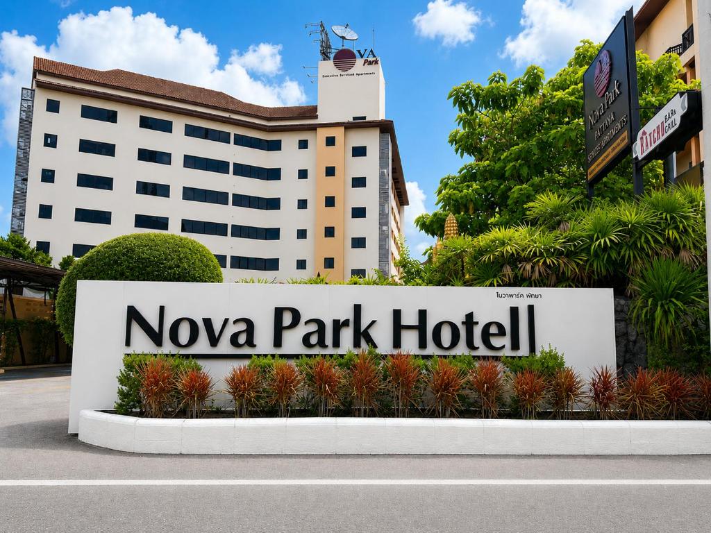 a sign for nova park hotel in front of a building at Nova Park Hotel Pattaya in Pattaya