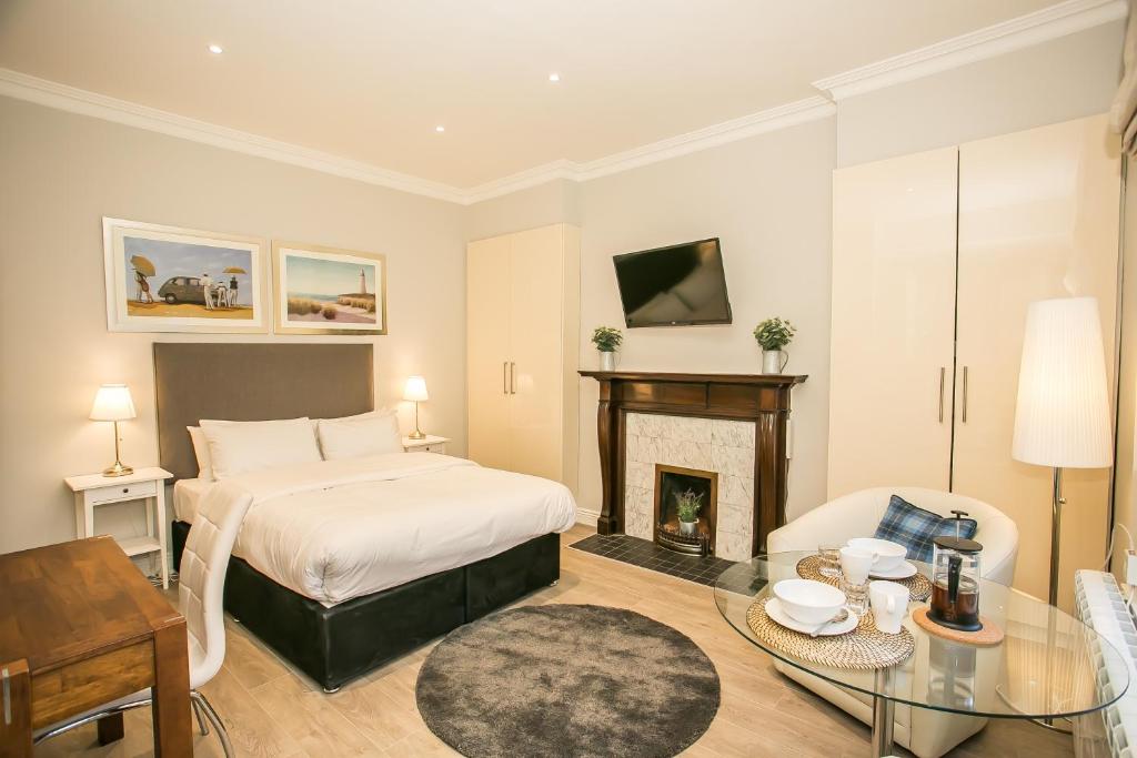 a bedroom with a bed and a fireplace at Grand Canal District Apartments in Dublin