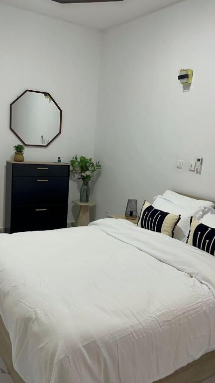 a bedroom with two beds and a mirror on the wall at Les résidences Merryke 1 in Abidjan