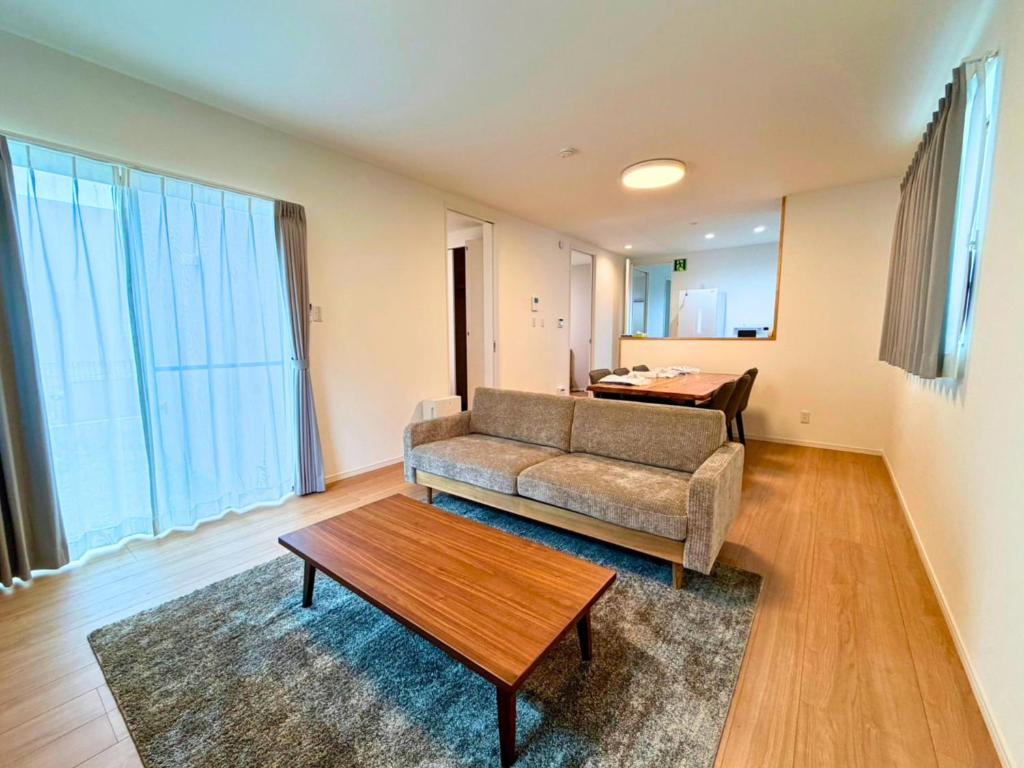 a living room with a couch and a table at Nakijin Terrace in Nakijin