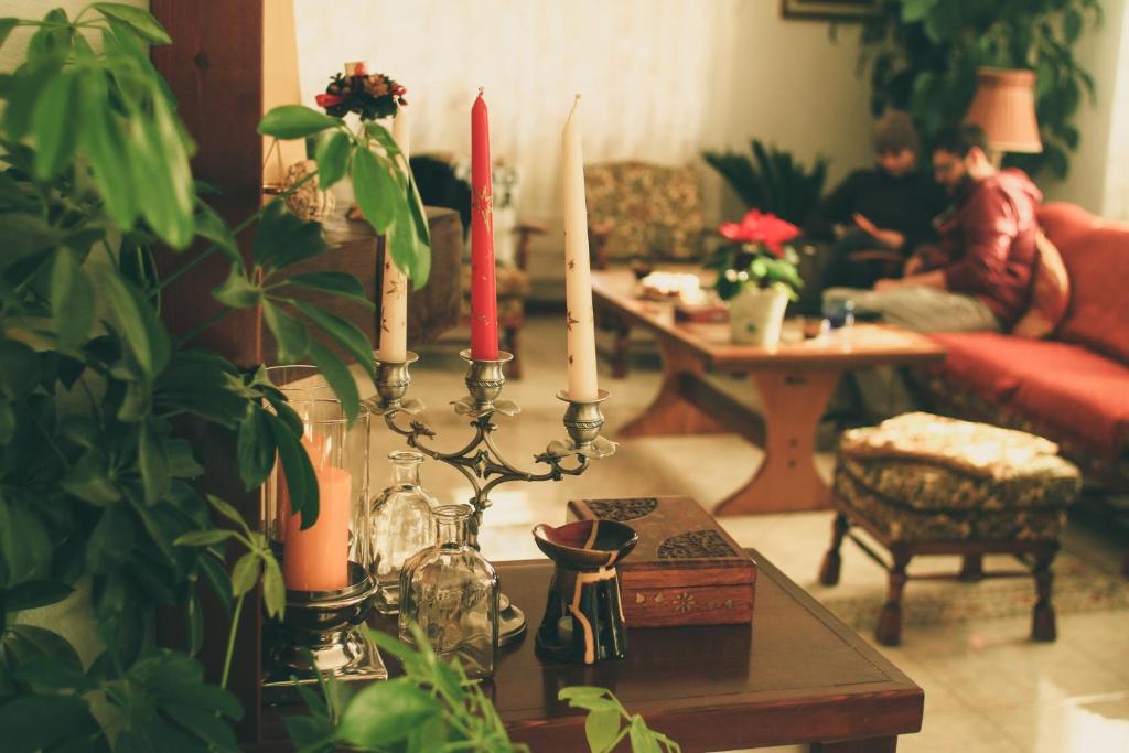 a living room with a table with two candles on it at Casa Renti in Novaci-Străini