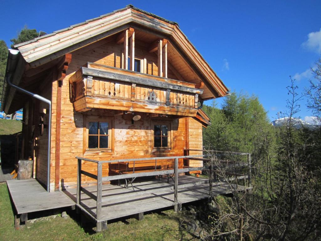 a small log cabin with a porch and a deck at Chalet Kornock in Turracher Hohe