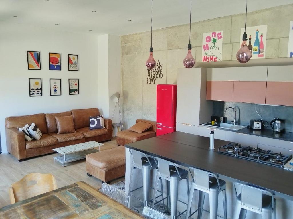 a kitchen and living room with a couch and a table at cardo village in Bastia