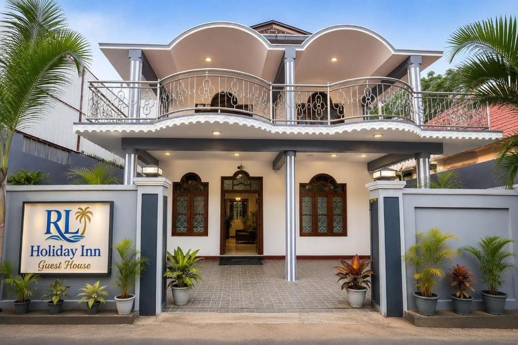 a house with a balcony on top of it at RL Holiday Inn in Jaffna