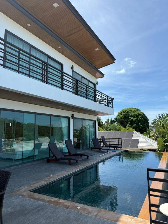 an image of a house with a swimming pool at Villa Fiesta, 5bd, palace in Mae Nam