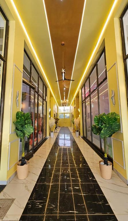 a hallway with potted plants in a building at Hotel gl palace & restaurant chomu in Jaipur