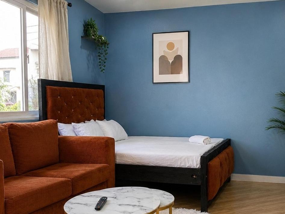 a living room with a bed and a couch at Studio in kilifi close to beach and supermarket in Kilifi