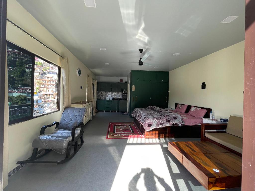 a bedroom with a bed and a chair at Ashirwad Homestay in Bhowāli